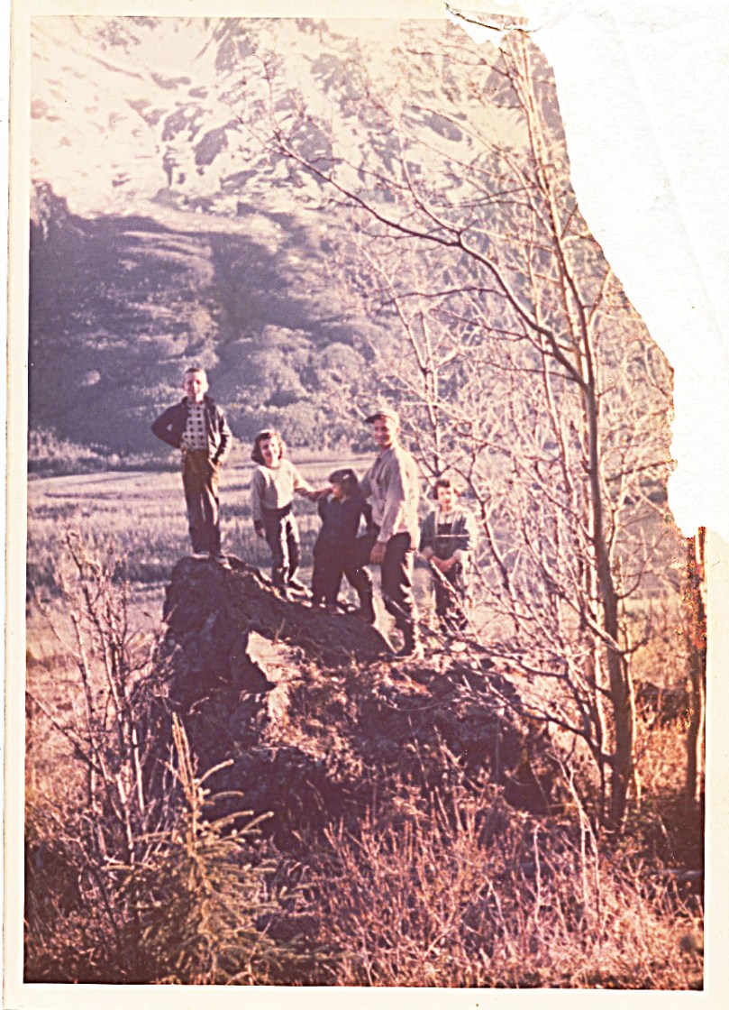 1958 family on the big rock above hut - dad found this spot when he first discovered the homestead site - damaged photo, but homepfully I'll come across a slide or negative -- I've always felt that my 7-year-old self is excluded in this picture -- I also can see my sadness in this one