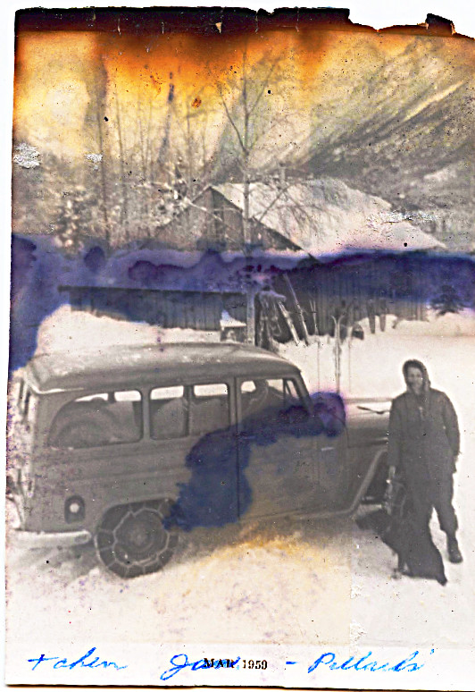 1959 - January - Dad, Jeep station wagon with chains on tired, at neighbor Pollard's house