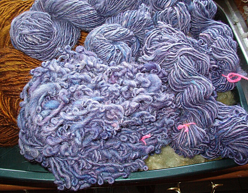 The purple fleece spun - the crinkly yarn still has to be wet again and stretched outside with weights hung from it to set the twist.