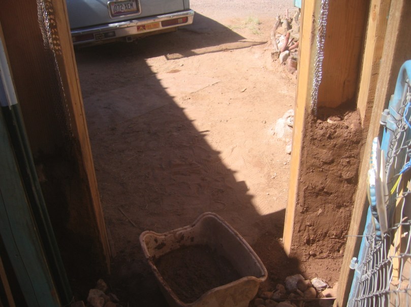Grounding the gateway to the earth with earth adobe and stones, making this structure impressively sturdy when completed